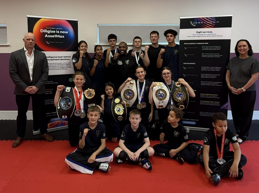 Team Nemesis sponsorship: the Fight Team with their World Championship belts and medals alongside AssetMax.ai, Reading, October 2026