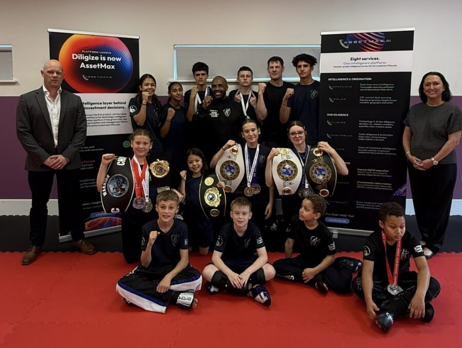 Team Nemesis sponsorship: the Fight Team with their World Championship belts and medals alongside AssetMax.ai, Reading, October 2026