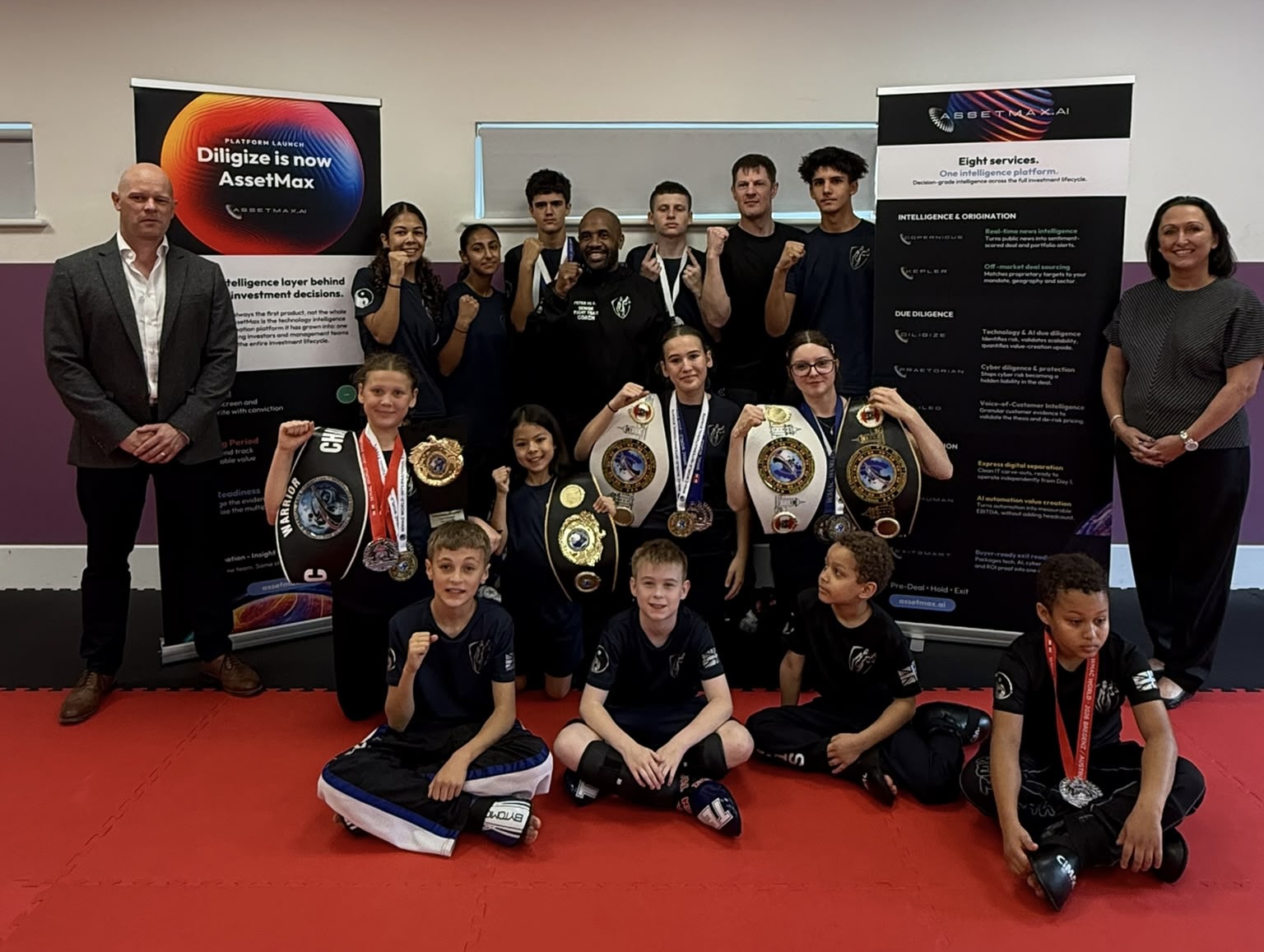 Team Nemesis sponsorship: the Fight Team with their World Championship belts and medals alongside AssetMax.ai, Reading, October 2026