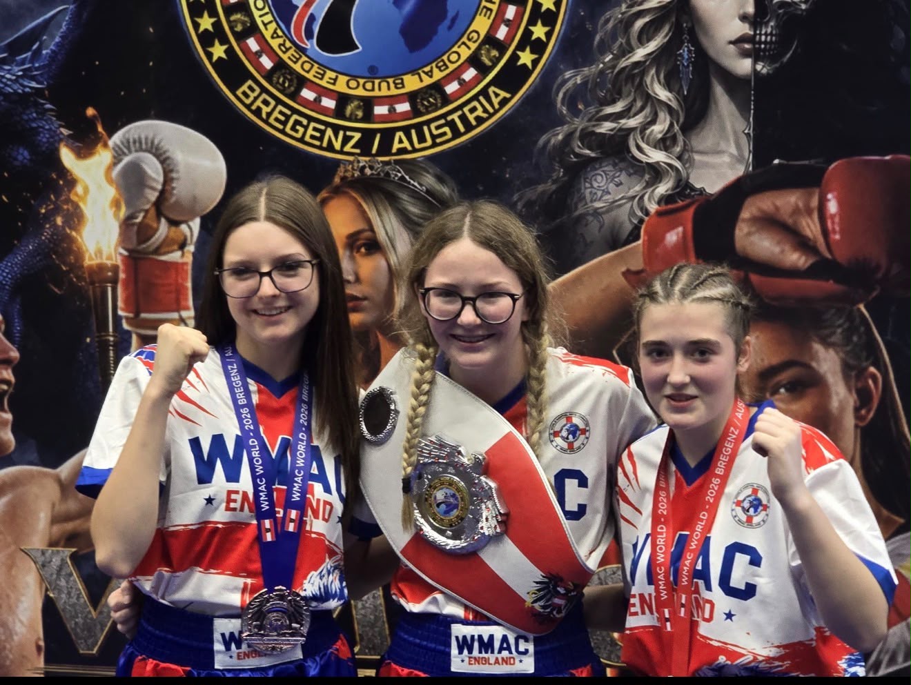 Three Team Nemesis fighters in WMAC England kit with their world medals